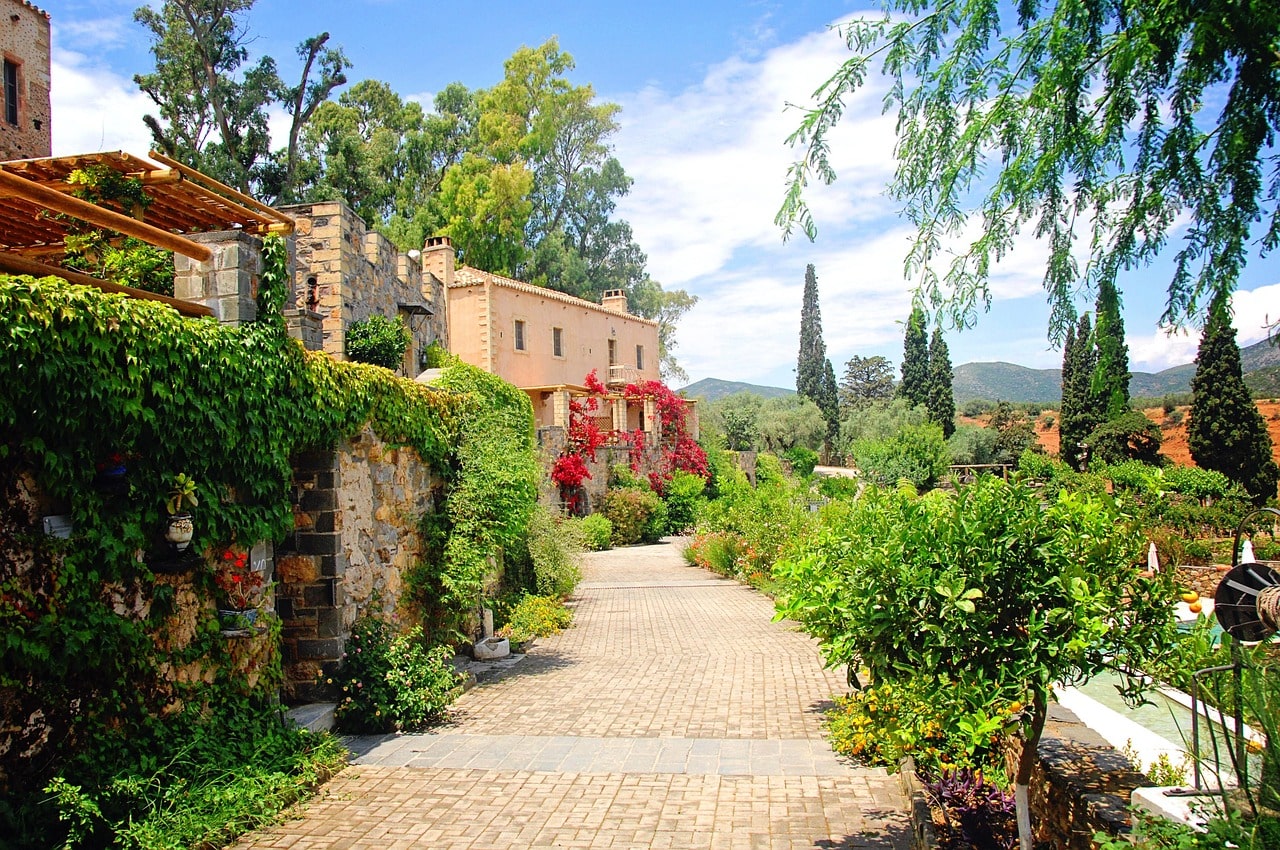 Path leading towards picturesque villa in lush green surroundings image