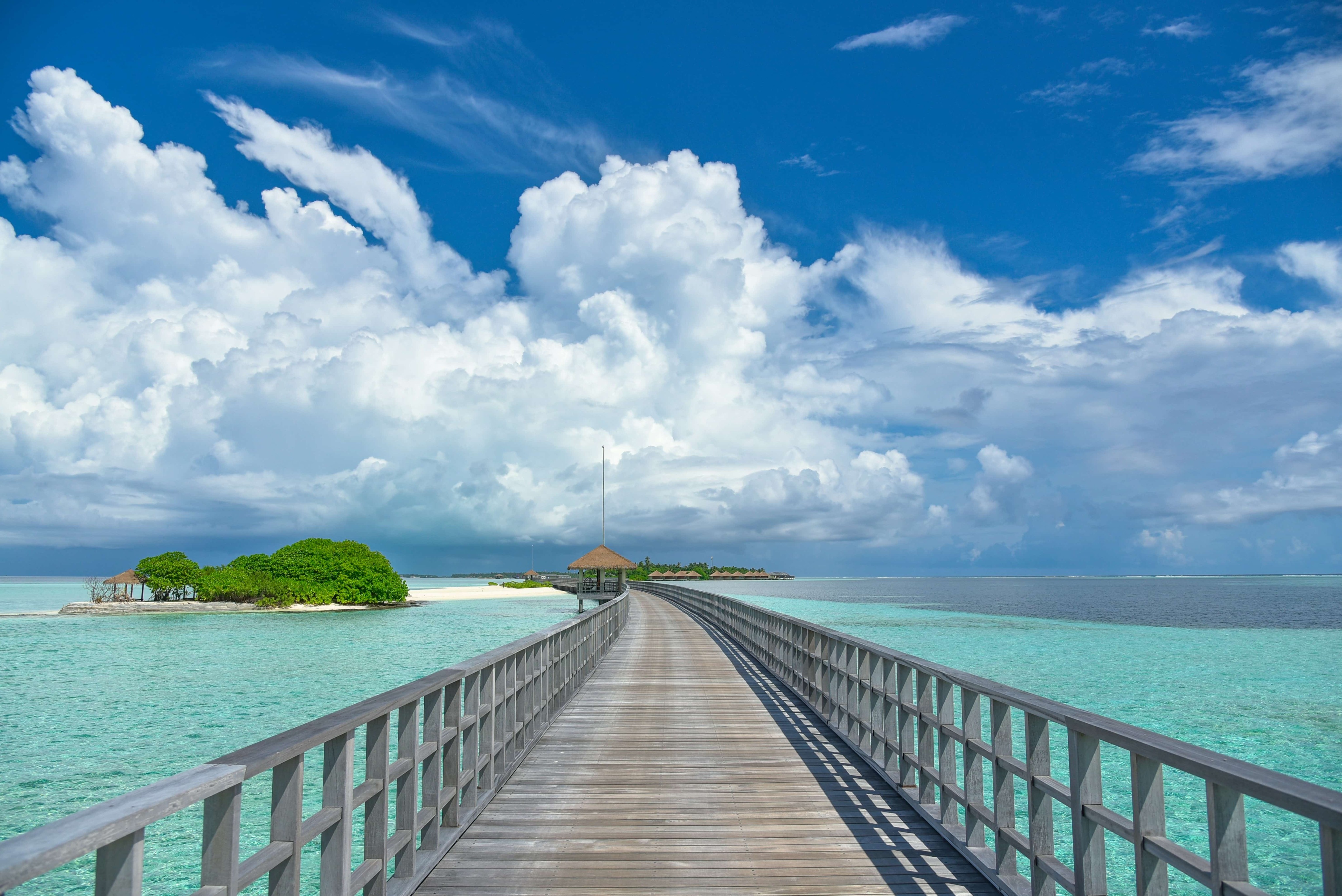 Long jetty leading across the water to a small island image