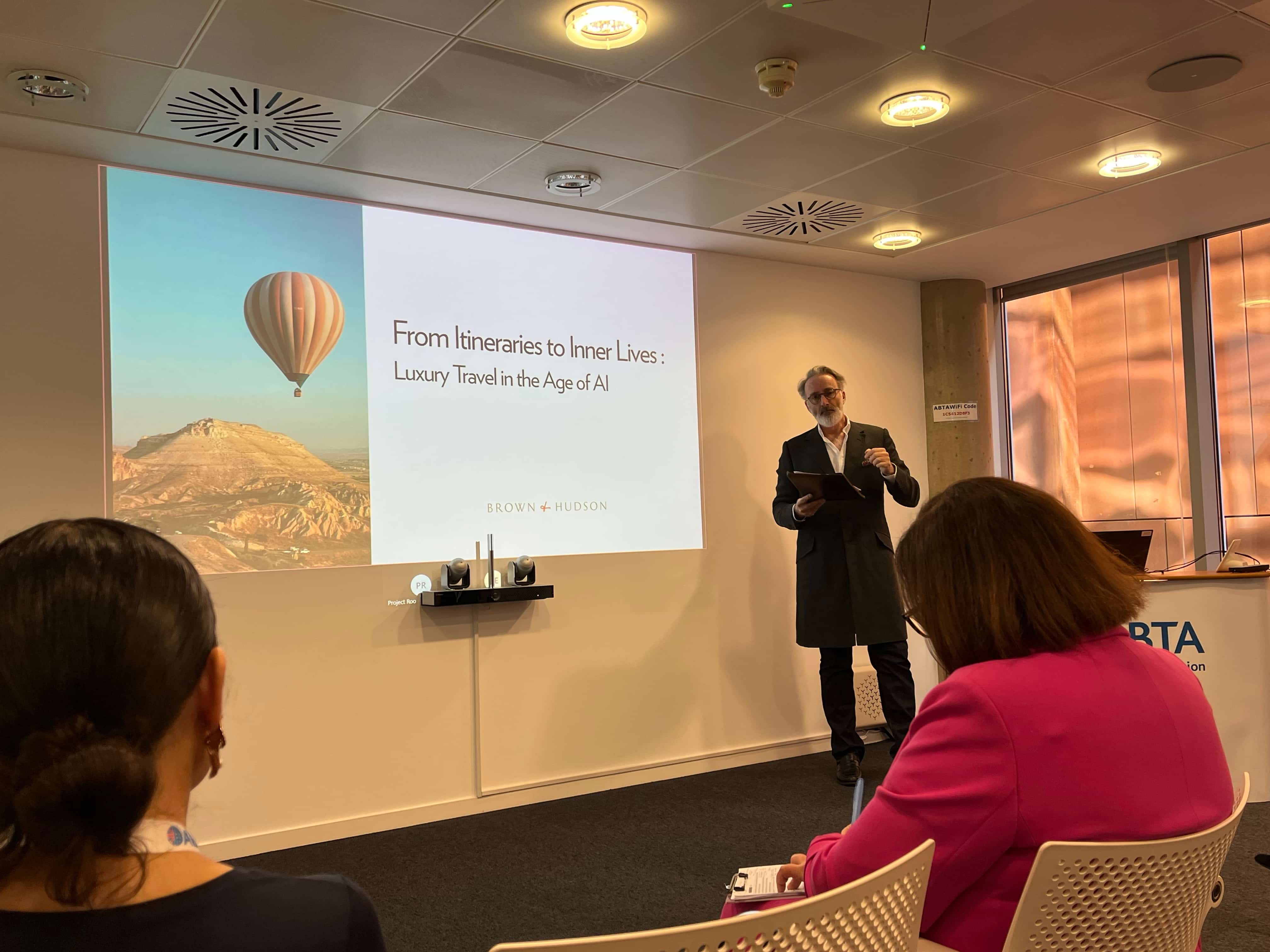 Speaker presenting at an ABTA luxury travel seminar, with a slide titled ‘From Itineraries to Inner Lives: Luxury Travel in the Age of AI' image